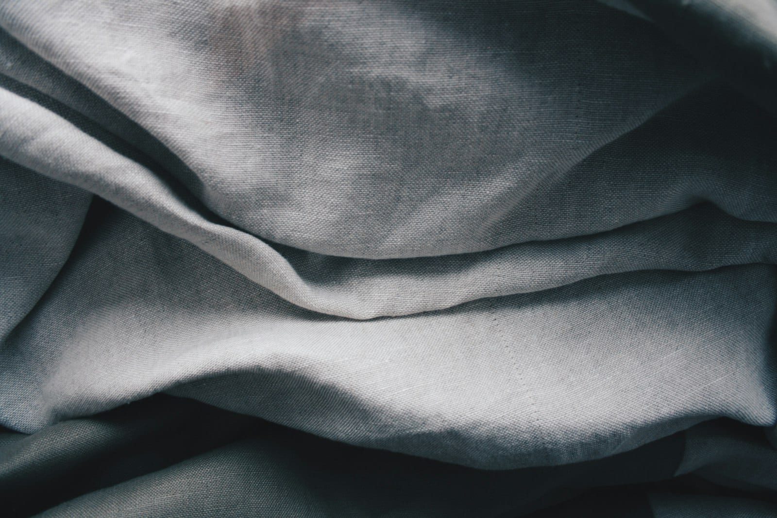 A close crop of soft woven cloth, echoing the texture of a Kito cover.